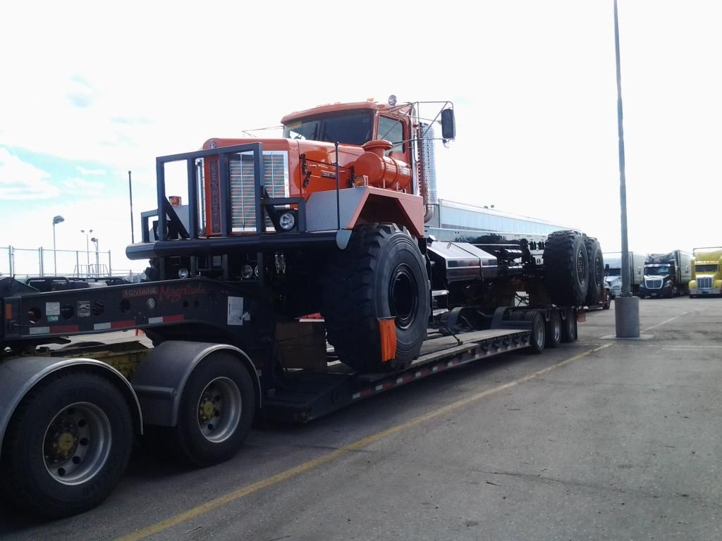 huge kenworth truck loaded on a flatbed